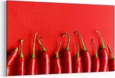 Schilderij - Chili pepper on red background, top view — 100x70 cm
