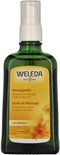 Groene glazen fles met Weleda massageolie. Op het gele etiket staat 'Massageolie' en 'Calendula'.