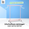 Roze kledingrek met uitschuifbare zijstangen voor jassen en accessoires.