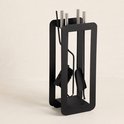 Zwarte metalen haardsethouder met vier stuks gereedschap in een minimalistisch design.