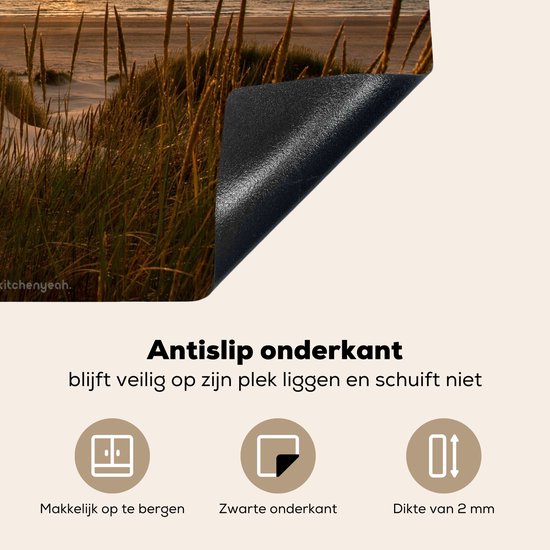 Antislip onderkant van een inductiebeschermer met duinenlandschap bij zonsondergang.