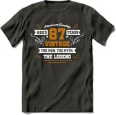 87 Jaar Legend T-Shirt | Goud - Wit | Grappig Verjaardag en Feest Cadeau Shirt | Dames - Heren - Unisex | Tshirt Kleding Kado | - Donker Grijs - XXL