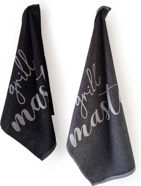 Torchons noirs et gris foncé avec le texte blanc 'grill master', suspendus à un mur blanc.