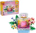 Bouteille de parfum LEGO Creator 3-en-1 avec étiquette "Flower Spark", fleurs roses et jaunes, et feuilles vertes.