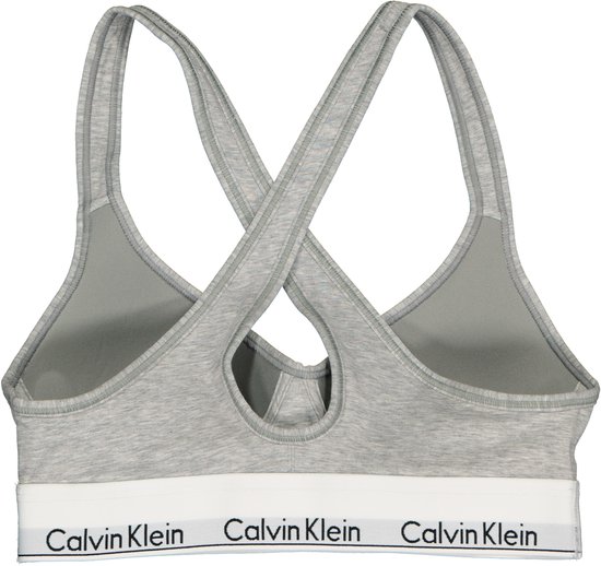 Grijze Calvin Klein bralette met gekruiste bandjes en witte band met logo.