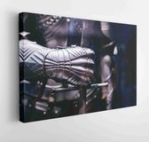 Canvas schilderij - Close up medieval steel armor holding a giant sword by hand  -     749276461 - 115*75 Horizontal