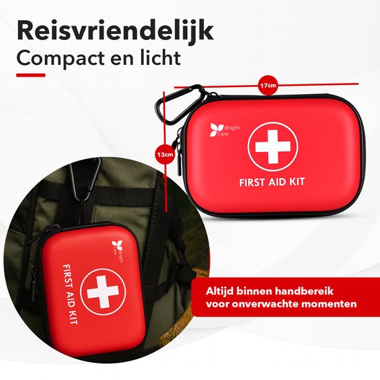 Rode compacte verbanddoos met afmetingen 13cm en 17cm, voorzien van een karabijnsluiting en een wit kruis. Wordt getoond naast een rugzak.