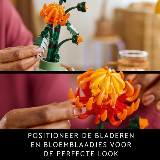 Mains ajustant les feuilles et pétales LEGO d'un chrysanthème orange.