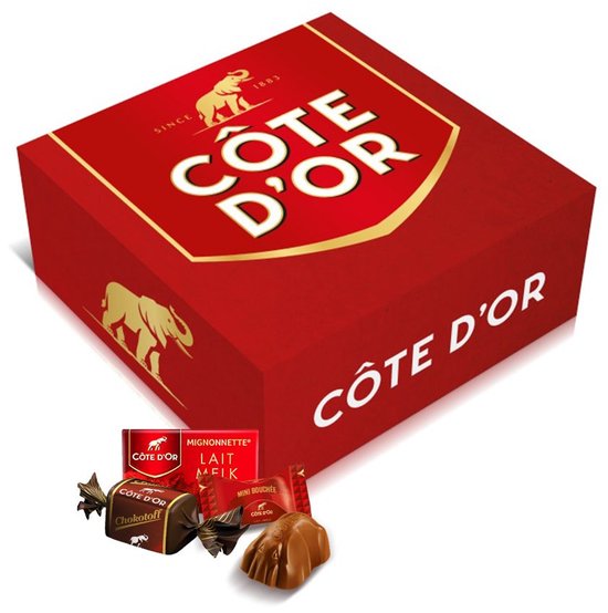 Une boîte cadeau Côte d'Or rouge avec des éléphants et logo dorés, montrant des exemples de Côte d'Or Mignonnette, Mini Bouchée et Chokotoff.