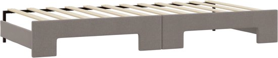 Grijze stoffen bedframe met houten lattenbodem, bestaande uit twee delen.