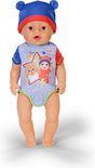 Baby pop met blauwe muts met oren en rompertje met sterrenprint en teddybeer.