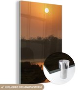 MuchoWow® Glasschilderij 40x60 cm - Schilderij acrylglas - Oranje zonsondergang bij het Nationaal park Chitwan in Nepal - Foto op glas - Schilderijen