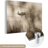 MuchoWow® Glasschilderij 150x100 cm - Schilderij acrylglas - Spitfire bij een donkere wolkenlucht - Foto op glas - Schilderijen