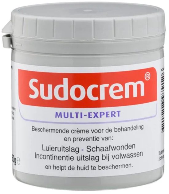 Sudocrem Multi-Expert pot met witte dop en label met rode Sudocrem tekst en informatie over luieruitslag, schaafwonden en incontinentie uitslag.
