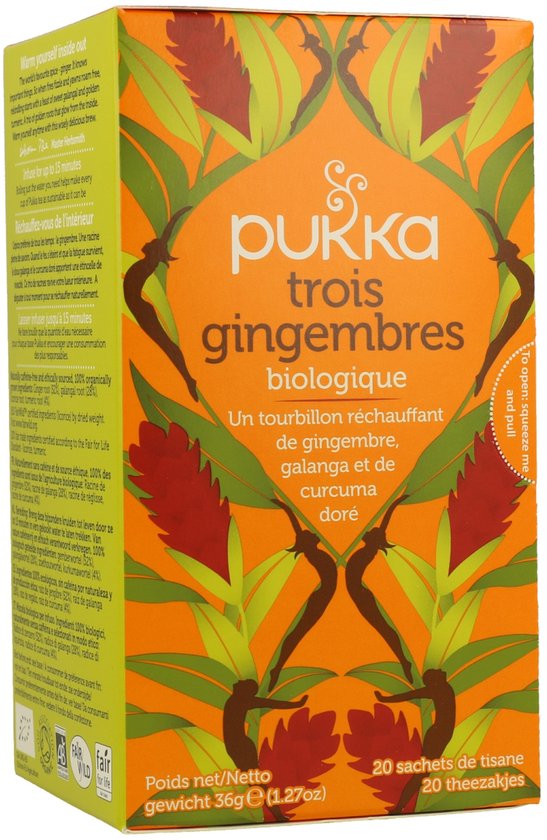 Pukka trois gingembres biologische thee verpakking met oranje achtergrond, gember bloemen en bladeren.