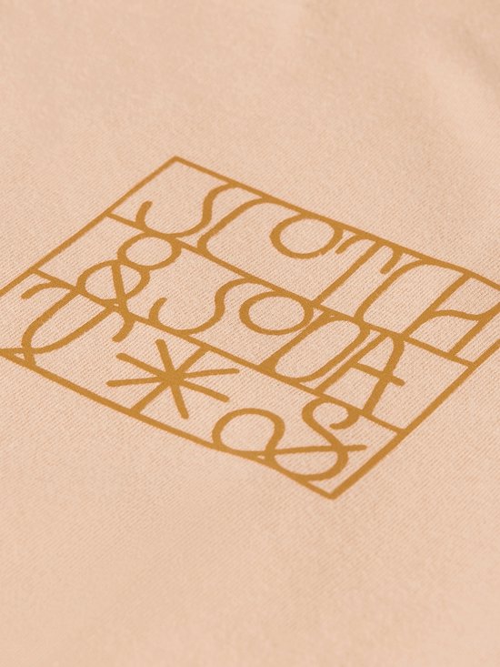 T-shirt rose pâle avec un logo graphique doré "Scotch & Soda".