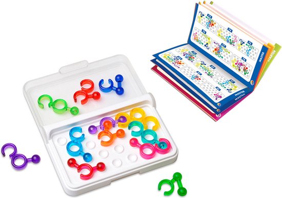 Gekleurde spelonderdelen in wit doosje en losse onderdelen. Open boek met puzzeloplossingen.