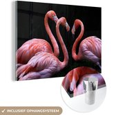 MuchoWow® Glasschilderij 120x80 cm - Schilderij acrylglas - Drie roze flamingo's weergegeven op een zwarte achtergrond - Foto op glas - Schilderijen
