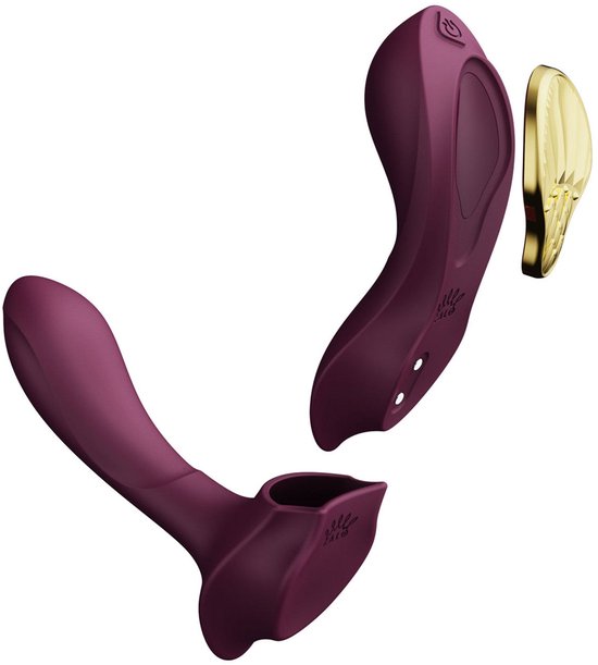 Vibrateur violet de forme incurvée avec accessoire doré.
