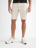 Man in beige shorts en witte sneakers.