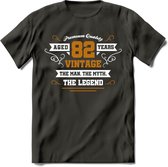 82 Jaar Legend T-Shirt | Goud - Wit | Grappig Verjaardag en Feest Cadeau Shirt | Dames - Heren - Unisex | Tshirt Kleding Kado | - Donker Grijs - M