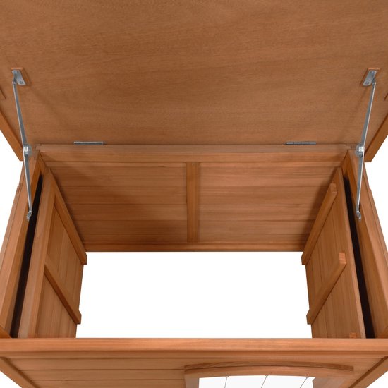 Binnenkant van een houten hondenhok met geopende deksel.