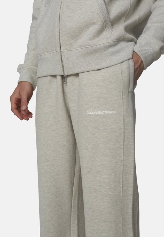 Close-up van grijze 'GOODFORNOTHING' joggingbroek met logo op de heup.
