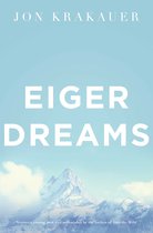 Boek "Eiger Dreams" van Jon Krakauer, met een besneeuwde bergtop op de achtergrond.
