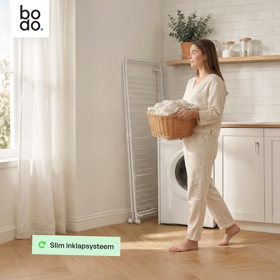 Een vrouw met een mand met was loopt langs een witte, ingeklapte droogtoren in een wasruimte.