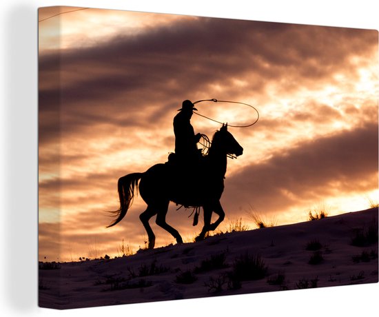 Canvas Schilderij Een eenzame cowboy bij zonsondergang - Wanddecoratie