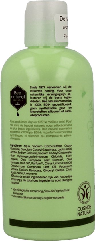 Achterkant van een lichtgroene fles shampoo van Bee Honest, met ingrediëntenlijst en COSMOS NATURAL keurmerk.