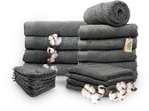 Een stapel donkergrijze handdoeken van Miss Towels, met katoenbloemen en verschillende maten handdoeken.
