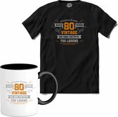 80 Jaar vintage legend - Verjaardag cadeau - Kado tip - T-Shirt met mok - Dames - Zwart - Maat 3XL