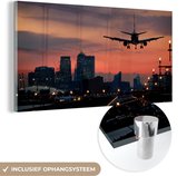 MuchoWow® Glasschilderij 80x40 cm - Schilderij acrylglas - Landend vliegtuig tijdens zonsopkomt - Foto op glas - Schilderijen