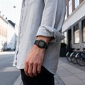 Zwart Casio horloge gedragen door een man met opgerolde mouwen.