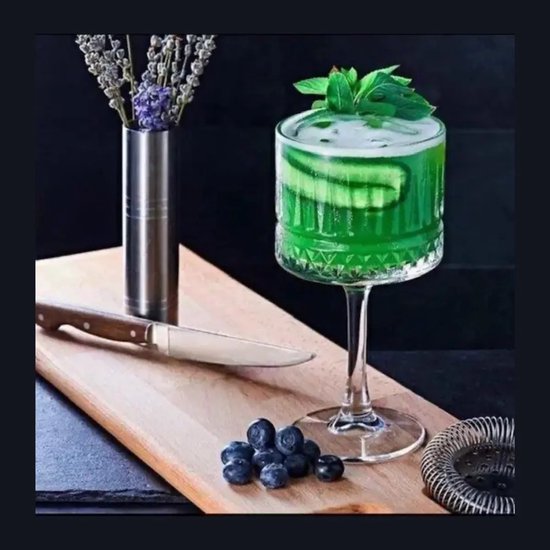 Groene cocktail met munt en komkommer in glas.