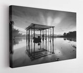 Canvas schilderij - Amazing Black & white scenery of traditional fishing boat at Tumpat, Malaysia with fisherman silhouette standing on the boat. Soft focus due to long exposure. -