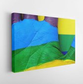 Canvas schilderij - Someone showing the palm of his hand painted as the rainbow flag over a rainbow flag -     136871510 - 40*30 Horizontal