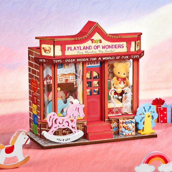 Miniatuur speelgoedwinkel 'Playland of Wonders' met rode gevel, stenen print, een roze hobbelpaard en speelgoed displays.