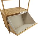 Crèmekleurige stoffen wasmand, deels uitgetrokken, met zilverkleurig handvat.