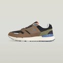 Zijaanzicht van een G-Star sneaker in beige suède en zwart mesh met blauwe en groene accenten.