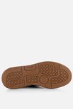 Witte sneakerzool met bruin Puma-logo en grip-patroon.