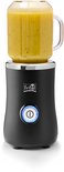 Zwarte Fritel blender met een beker gevuld met een groene smoothie.