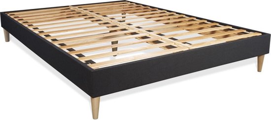 Zwart bedframe met houten pootjes en lattenbodem.