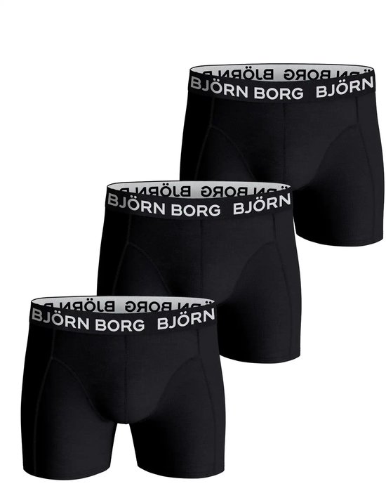 Drie zwarte Björn Borg boxershorts met wit logo op de elastische band, opgestapeld.