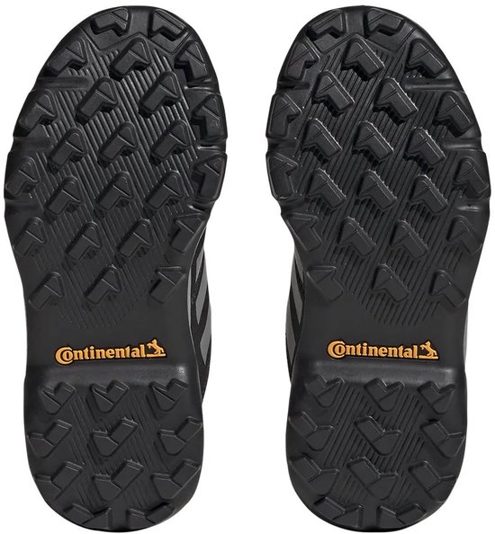 Zolen van zwarte wandelschoenen voor kinderen met Continental-logo en profiel.