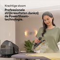Vrouw strijkt met zwart Braun CareStyle 5 strijkijzer, stoom komt vrij. Krachtige stoom.