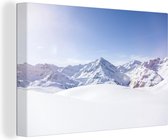 Canvas Schilderij Uitzicht op het besneeuwde winterlandschap in Oostenrijk - 120x80 cm - Wanddecoratie