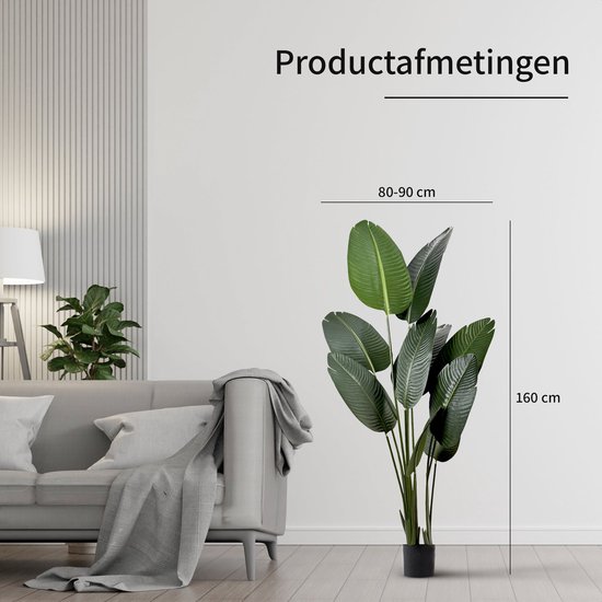 Groene Strelitzia kunstplant, 160 cm hoog en 80-90 cm breed, naast een bank.