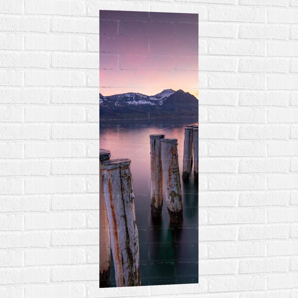 Muursticker - Houten Palen in het Meer van Berggebied tijdens Zonsondergang met Paarse Glo